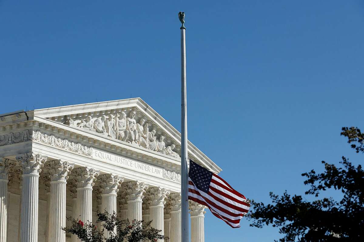 The American flag flies at half staff in memory of late Justice Ruth Bader Ginsburg outside the Supreme Court in Washington, D.C.