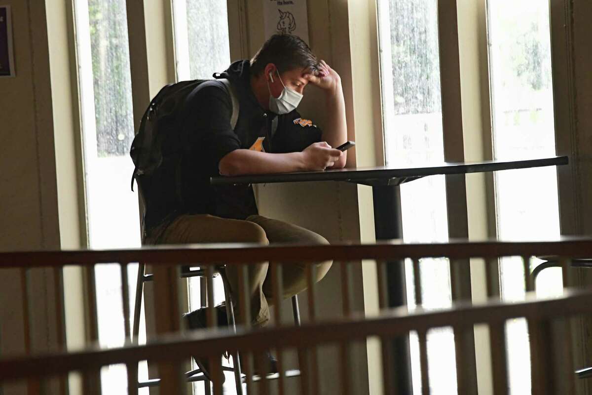 A student is seen on his phone in the campus center of University at Albany on Friday, Sept. 25, 2020 in Albany, N.Y. (Lori Van Buren/Times Union)