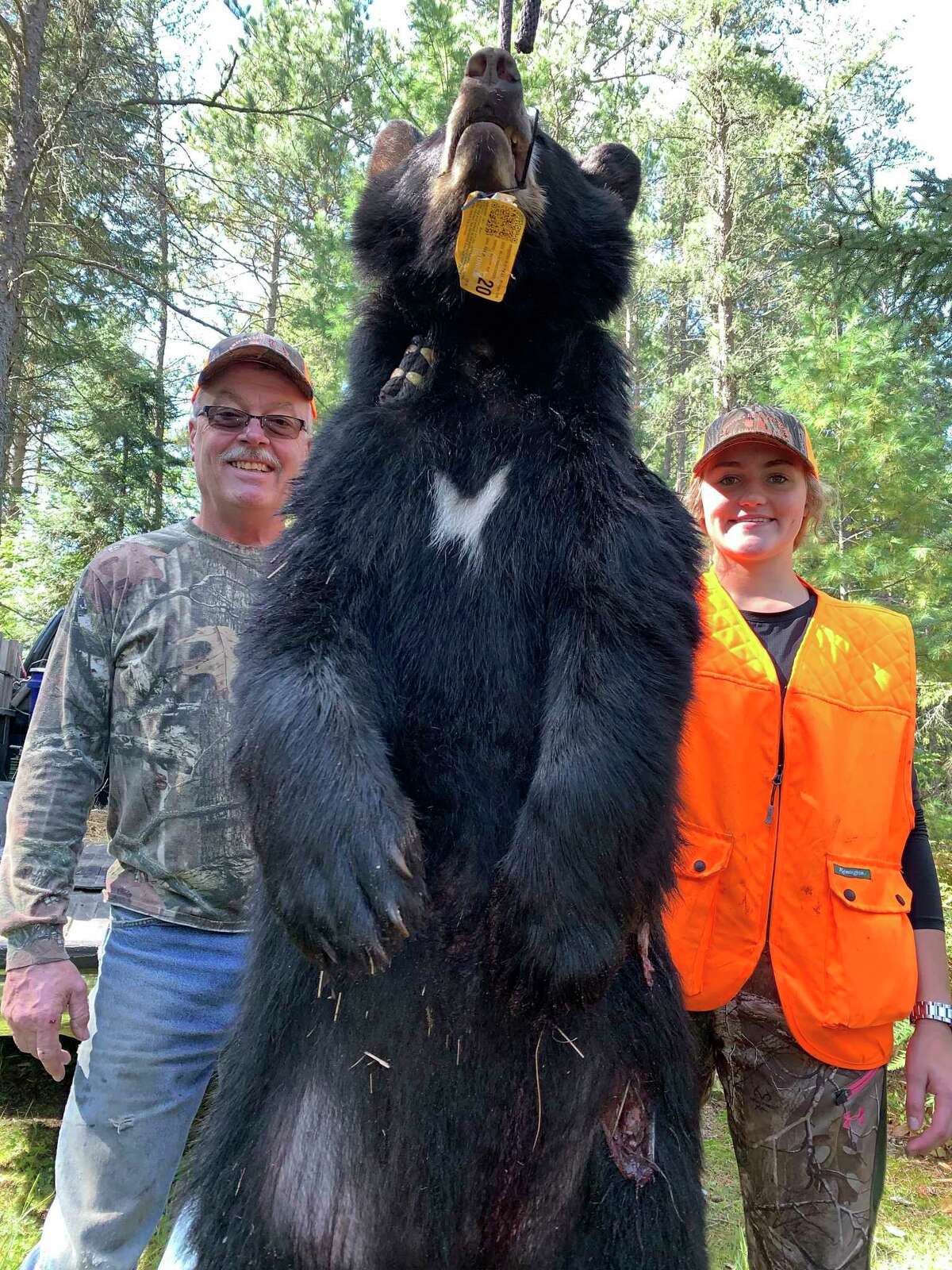 Natalie Chapman (right) of Big Rapids shows her bear along with Kip Cameron of Kip Cameron Bear Guide Services out of Newberry. (Courtesy photo)