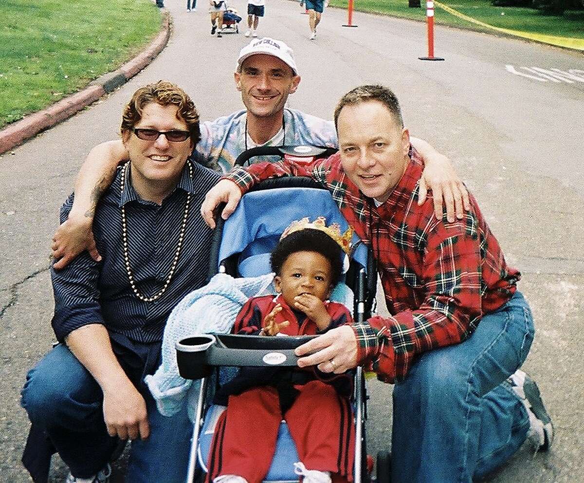 From left: Jon “Uncle Jon” Wieland, Tim Powers, Zane and Kevin Fisher-Paulson pose during the AIDS Walk in 2004.