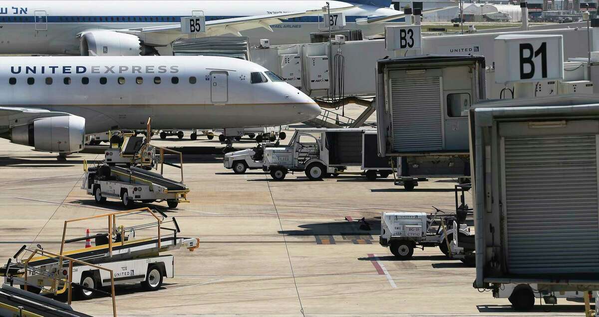 A lone United Express jet parks at a gate at San Antonio International Airport on Monday, May 18, 2020.
