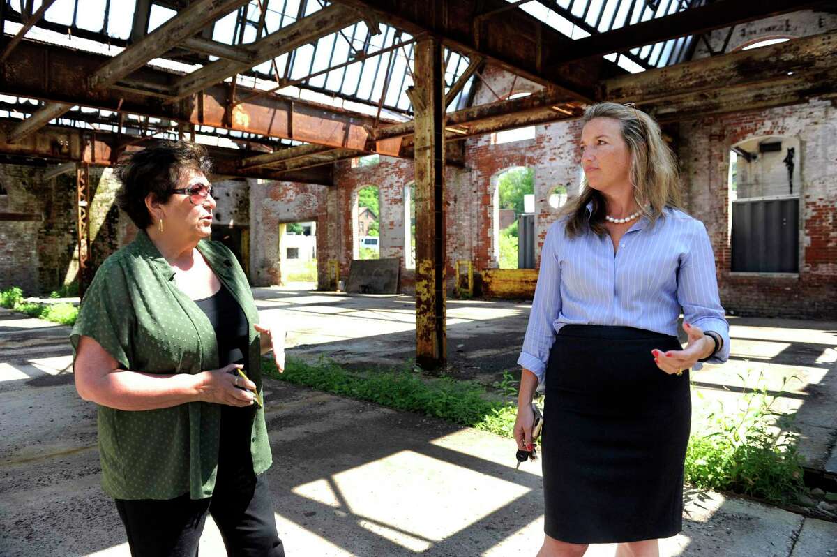Patricia Moisio, left, Redding town tax collector and Julia Pemberton, first selectman talk about the former Gilbert and Bennett wire mill in Redding, Thursday, August 7, 2014.