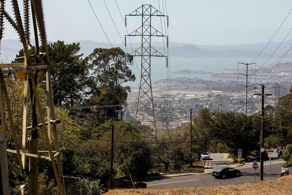 High-voltage power lines over homes and dry grass on Terrace Drive in El Cerrito pose a danger during wildfire season.