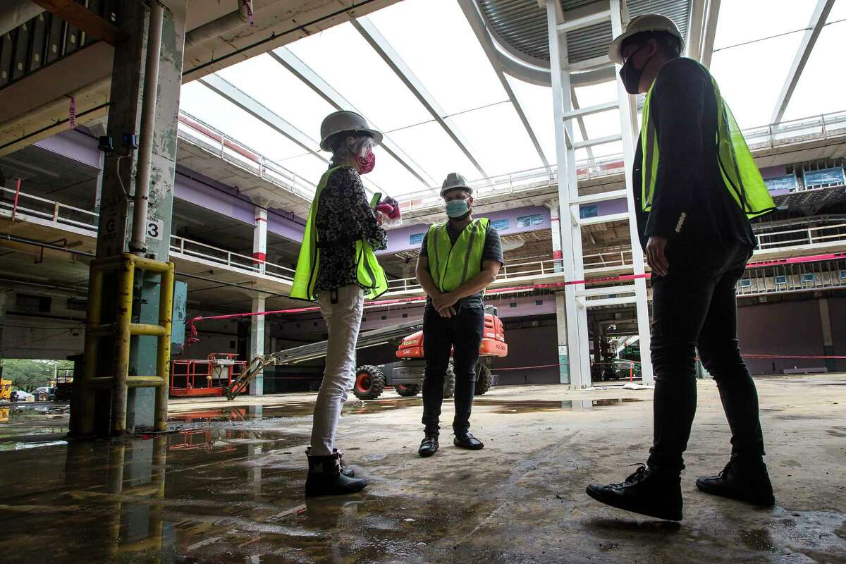 Judy Nyquist, left, and Derrick Diotalei, and Kirby Liu, of Lovett Commercial, tour POST Houston, the downtown redevelopment of the former Barbara Jordan Post office Thursday, Sept. 24, 2020 in Houston. The historic former Barbara Jordan Post Office is being redeveloped to include a six-acre rooftop farm and park with panoramic skyline views of Houston. Lovett Commercial is developing the space, calling it POST Houston with plans to include experimental shopping options, an international food hall, co-working offices, and a music venue.