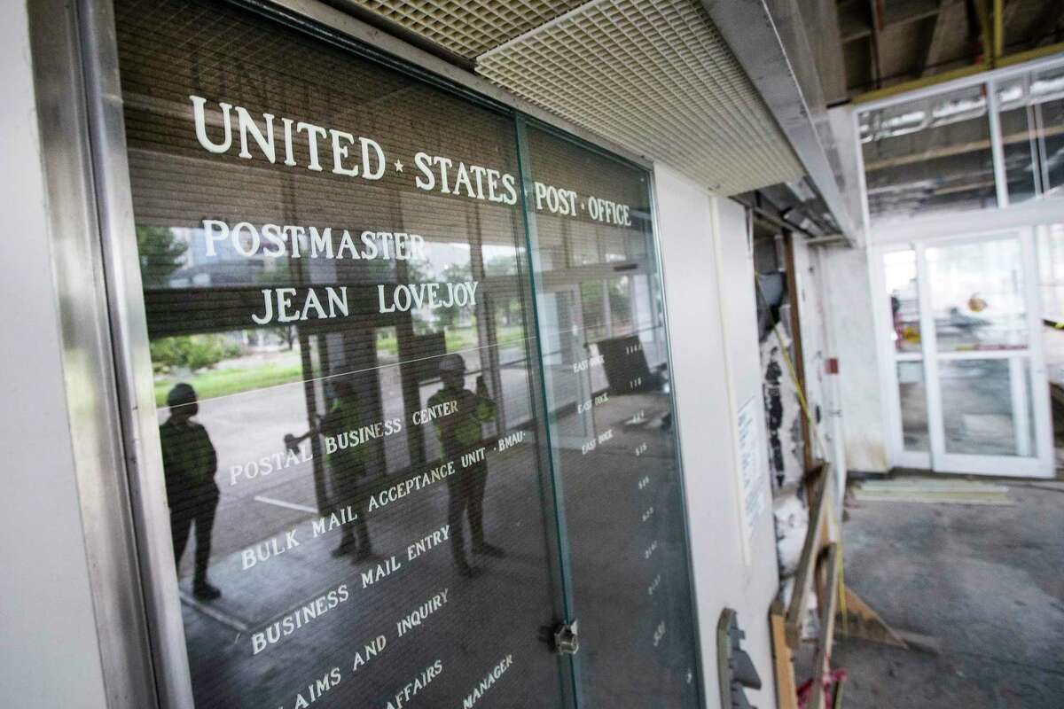 The U.S. Post Office sign remains inside the main entrance of POST Houston, the downtown redevelopment of the former Barbara Jordan Post office Thursday, Sept. 24, 2020 in Houston. The historic former Barbara Jordan Post Office is being redeveloped to include a six-acre rooftop farm and park with panoramic skyline views of Houston. Lovett Commercial is developing the space, calling it POST Houston with plans to include experimental shopping options, an international food hall, co-working offices, and a music venue.