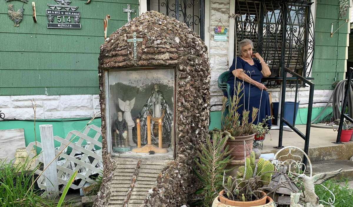 Andrea Gomez sits outside her San Antonio home, which has a yard shrine dedicated to La Virgen de San Juan de Los Lagos. The shrine dates back around 60 years.