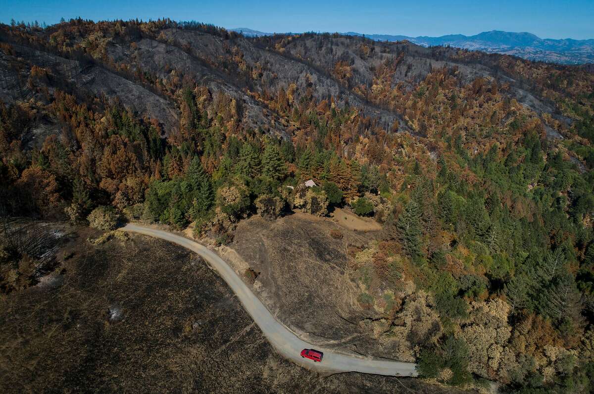 A truck makes its way up a private road off Sweetwater Springs Road in the areas devastated by the Walbridge fire outside Healdsburg, Calif., on Wednesday, September 23, 2020.