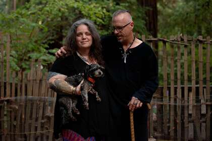 Melinda and Daniel McNutt with one of their dogs, Mojo, on their property in Boulder Creek. After the CZU blaze forced them to evacuate, the McNutts spent weeks in different temporary housing situations. Most of them were less than ideal and hard on Daniel’s injured back.