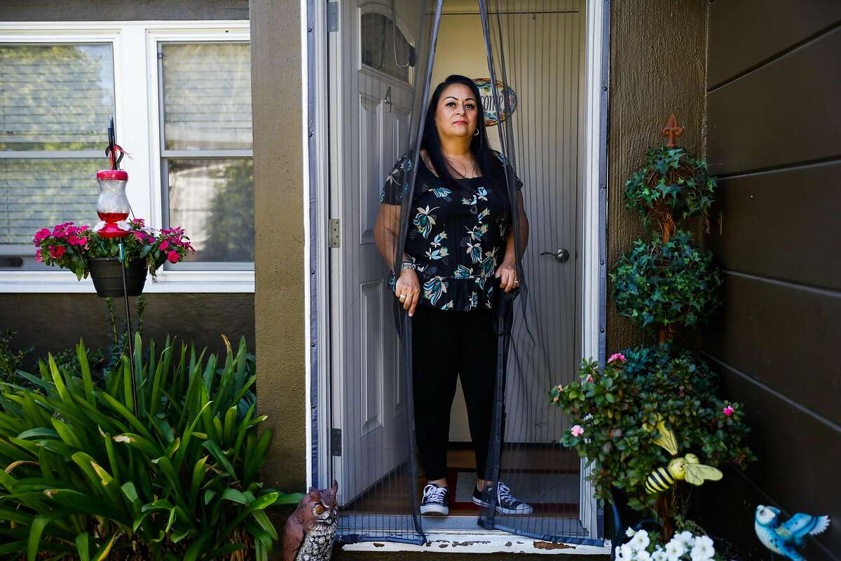 Charlotte Juarez poses for a portrait at her home on Thursday, Sept. 24, 2020 in Burlingame, California. Charlotte was in the hospital with the coronavirus in June and is still experiencing lingering effects including fatigue and heart palpitations.