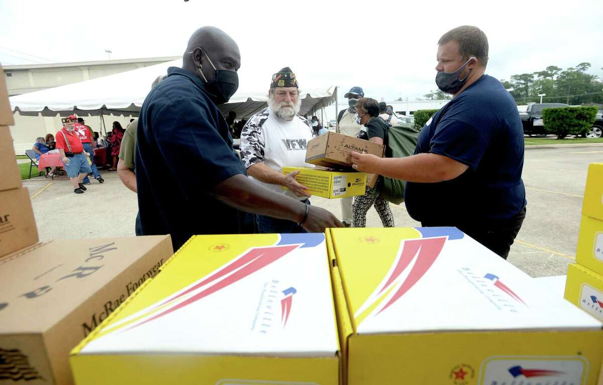 Albert Darby (left) and Donald Lotman gather boxes of boots donated from area army bases for veteran Jeff Courts during the annual Southeast Texas Stand Down 2020 held at the Veteran's Center in Beaumont Friday. Multiple services, agencies, and give-aways were available for veterans and the homeless. Similar events are held through the year in other Southeast Texas locations, including one in May in Orange and in January in Port Arthur. Photo taken Friday, September 25, 2020 Kim Brent/The Enterprise