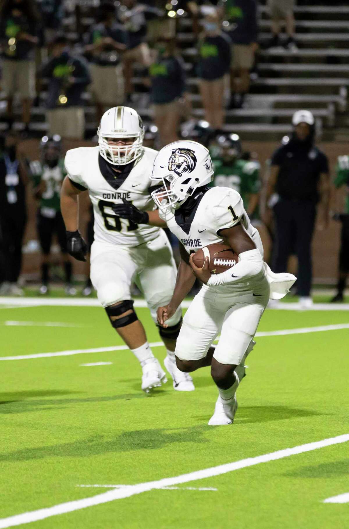 Conroe quarterback Jalen Williams (1) looks for an opening to pass the ball during the second quarter of a non-district football game against Mayde Creek at Rhodes Stadium in Katy, Friday, Sept. 25, 2020.