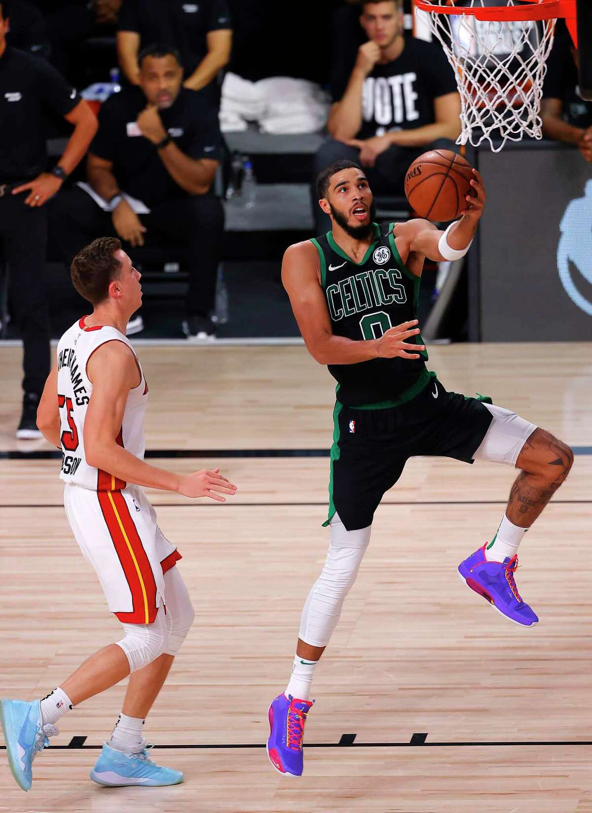 LAKE BUENA VISTA, FLORIDA - SEPTEMBER 25: Jayson Tatum #0 of the Boston Celtics goes for a lay-up against Duncan Robinson #55 of the Miami Heat during the fourth quarter in Game Five of the Eastern Conference Finals during the 2020 NBA Playoffs at AdventHealth Arena at the ESPN Wide World Of Sports Complex on September 25, 2020 in Lake Buena Vista, Florida. NOTE TO USER: User expressly acknowledges and agrees that, by downloading and or using this photograph, User is consenting to the terms and conditions of the Getty Images License Agreement. (Photo by Mike Ehrmann/Getty Images)