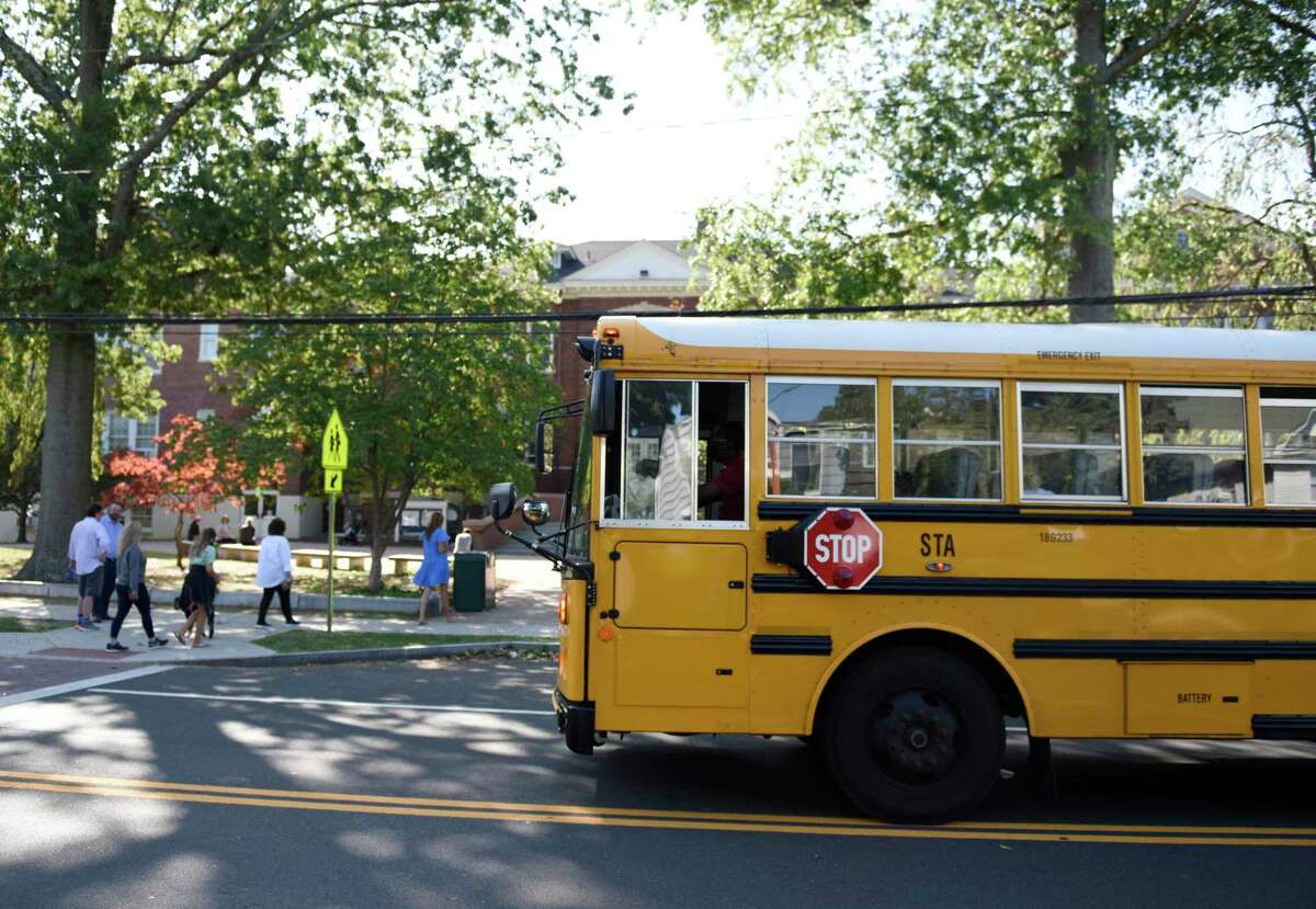 A school bus picks up students during dismissal at Old Greenwich School in Old Greenwich, Conn. Wednesday, Sept. 23, 2020.