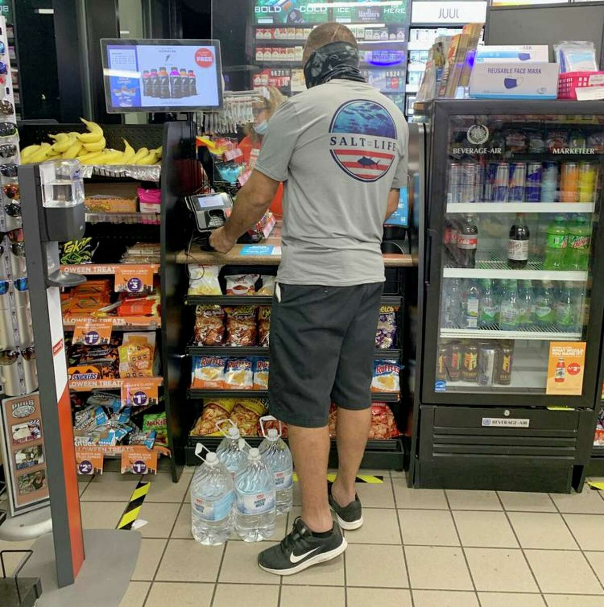 A customer buys water in Lake Jackson late Friday shortly after news spread of a do-not-use order from Brazosport Water Authority after a 6-year-old boy’s death by a brain-eating amoeba.