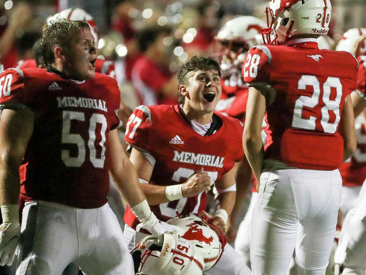 Memorial Mustangs Jack Dragna (50), Patrick Haas Smith (37) and linebacker Mueller Thomas (28) celebrate during the second half of a football game Thursday, Sept. 24 2020, at Darrell Tully Stadium in Houston.