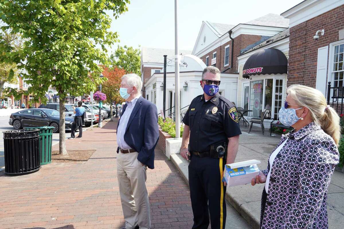 First Selectman Kevin Moynihan stood with Chief of Police Leon Krolikowski and Administrative Officer Tucker Murphy across from the New Canaan Playhouse waiting to hand out masks to anyone not wearing one on Friday, Sept. 25, 2020.