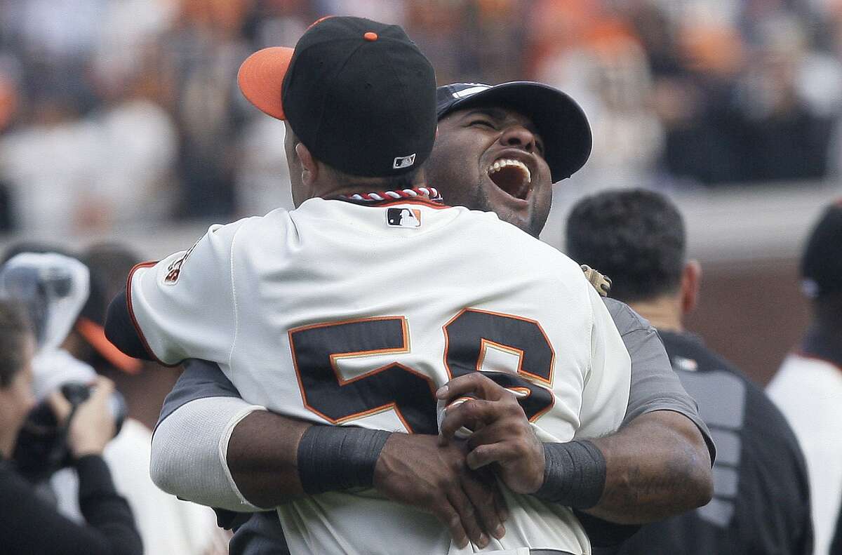 San Francisco Giants' Pablo Sandoval, facing, and Andres Torres celebrate after beating the San Diego Padres 3-0 to clinch the NL West in a baseball game in San Francisco, Sunday, Oct. 3, 2010. (AP Photo/Jeff Chiu)