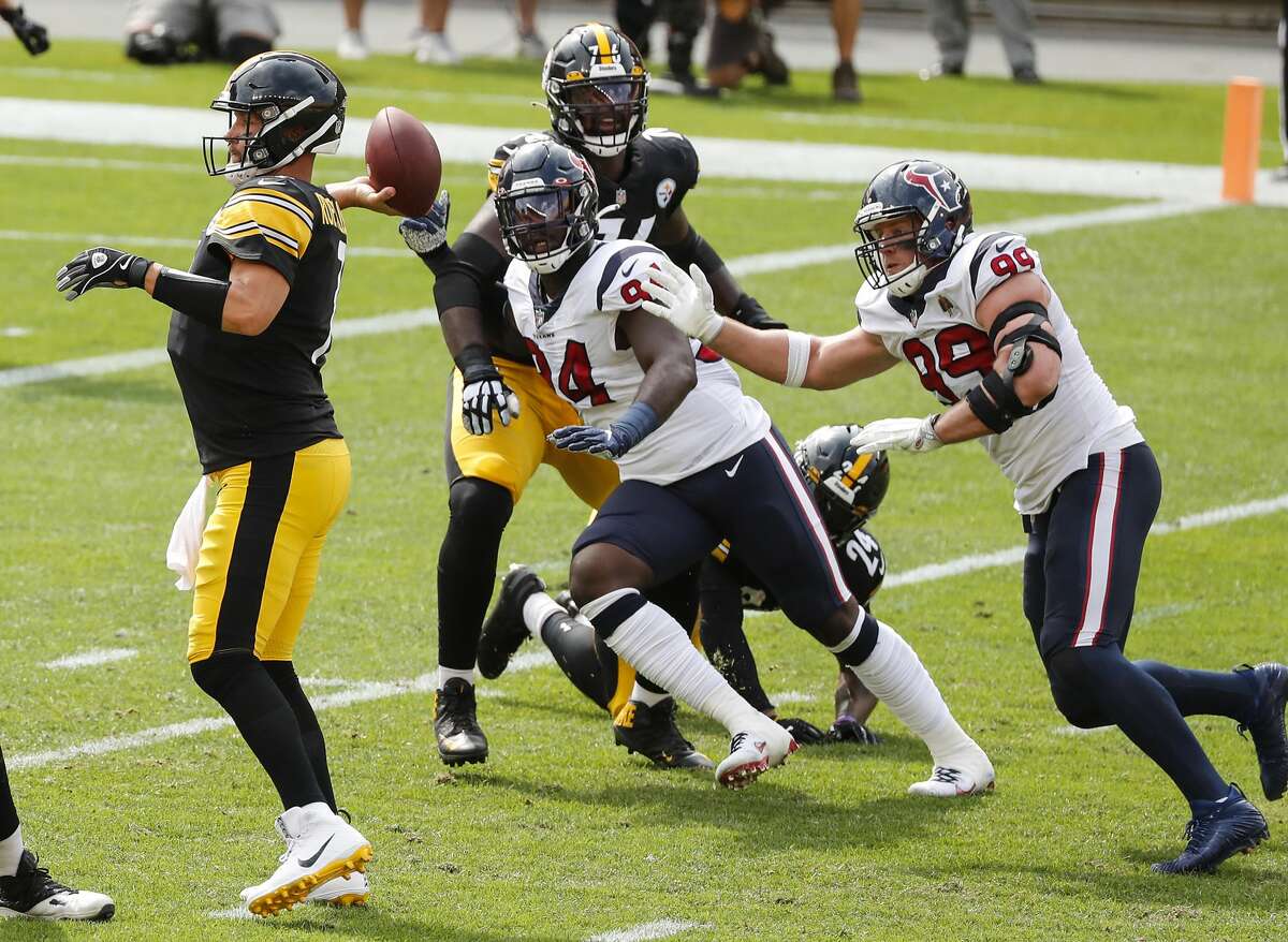 Houston Texans defensive ends Charles Omenihu (94) and J.J. Watt (99) chase Pittsburgh Steelers quarterback Ben Roethlisberger (7) out of the pocket during the first half of an NFL football game at Heinz Field on Sunday, Sept. 27, 2020, at Raymond James Stadium in Pittsburgh.