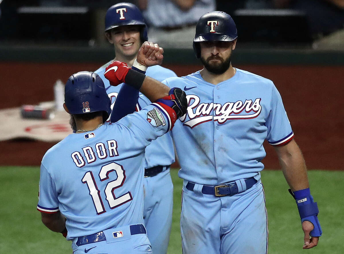 Texas Rangers celebrates a three-run home run with Joey Gallo #13 and Nick ...