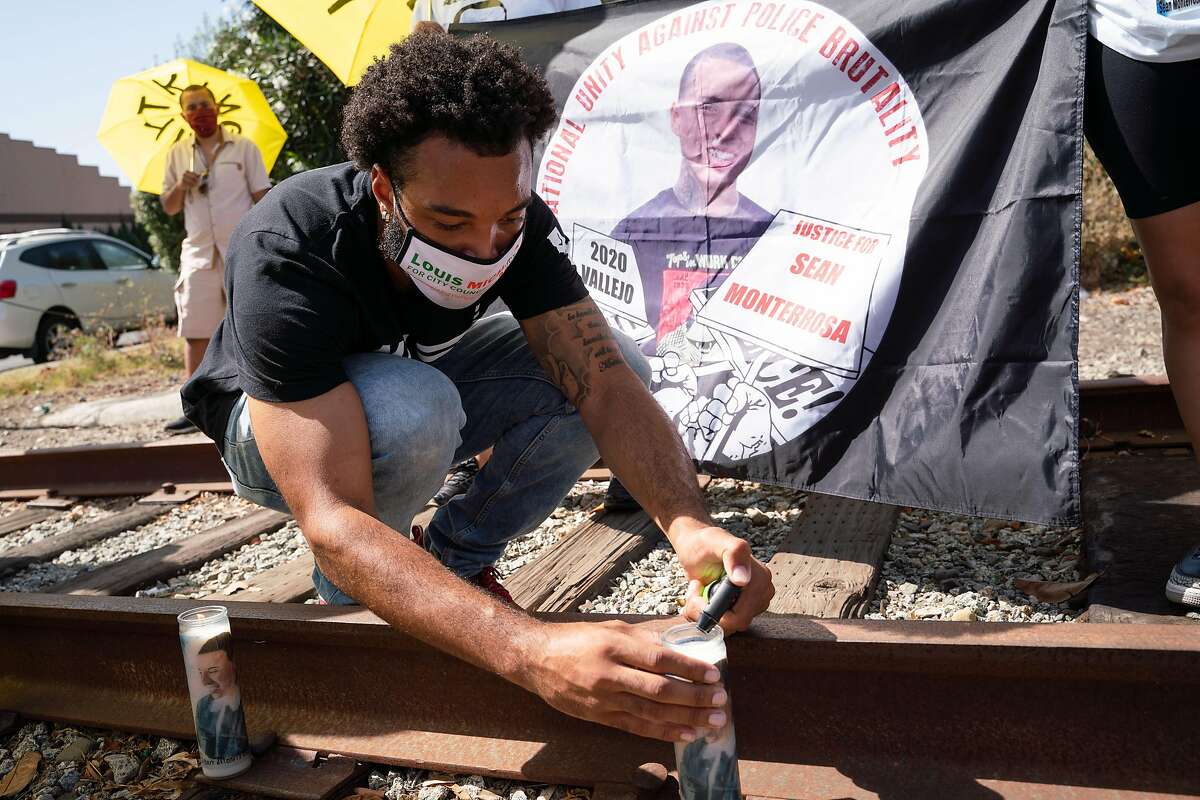 Vallejo City Council candidate Louis Michael lights a candle in honor of Sean Monterrosa.