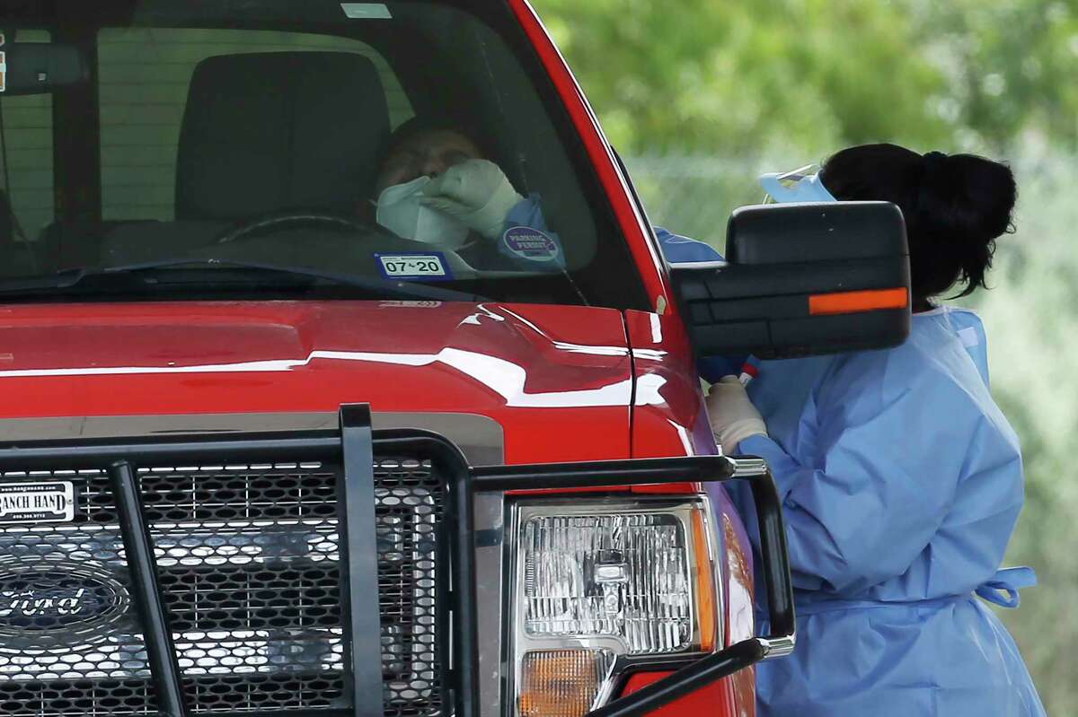 Bexar County’s death toll has climbed to 1,130 since the start of the pandemic, an increase of 56 from Saturday. That includes three new deaths and 53 deaths verified by Metro Health from earlier this summer. In this June photo, personnel conduct COVID-19 testing at the Texas Med Clinic Southwest drive-thru testing site on Southwest Military Drive.
