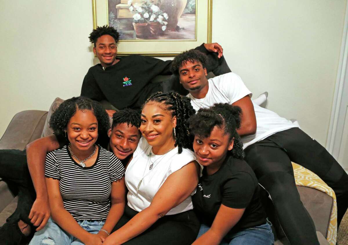 Toni Livingston is bracketed by hertwins Alicia Rimpson, in the stripes, and Naomi. Looking in between Alicia and Livingston is Antonio Rimpson with his triplets Jalen ,top left, and Sishman, behind the group. Livingston’s grandparents had 21 children, including five sets of twins.