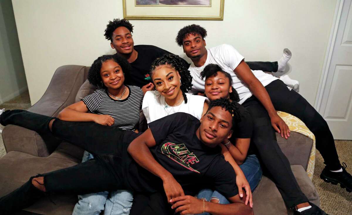 Toni Livingston poses with five of her six children. Her eldest, Ameia Rimpson is at college. Triplets Sishman Rimpson, in the white T-shirt, and Jalen are in the back row, while Antonio is on her lap. Her twins, Alicia, in the stripes, and Naomi are bracketing her.
