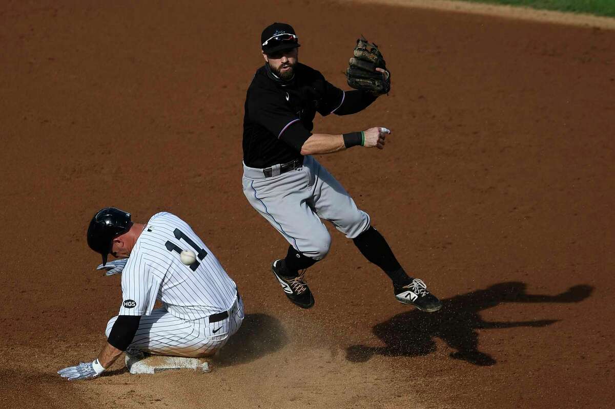 NEW YORK, NEW YORK - SEPTEMBER 27: Jon Berti #5 of the Miami Marlins turns a double play as Brett Gardner #11 of the New York Yankees slides into second during the second inning at Yankee Stadium on September 27, 2020 in the Bronx borough of New York City. (Photo by Sarah Stier/Getty Images)