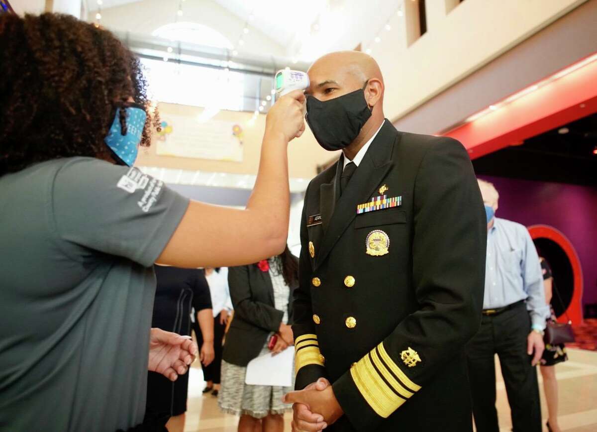 U.S. Surgeon General Jerome Adams has his temperature checked before a meeting with local political and health officials at The Health Museum on Sunday, Sept. 26, 2020, in Houston.