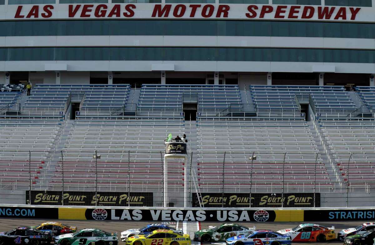Drivers pass the start finish line during a NASCAR Cup Series auto race Sunday, Sept. 27, 2020, in Las Vegas. The race was run without fans due to COVID-19. (AP Photo/Isaac Brekken)