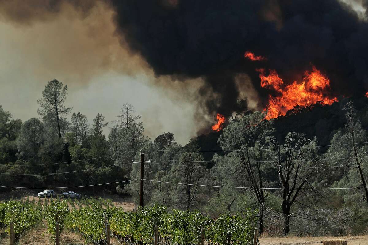 Two CalFire trucks are stationed near Viader Vineyards & Winery above Bell Canyon Reservoir as the Glass fire burned north of St. Helena, Calif., on Sunday, September 27, 2020.
