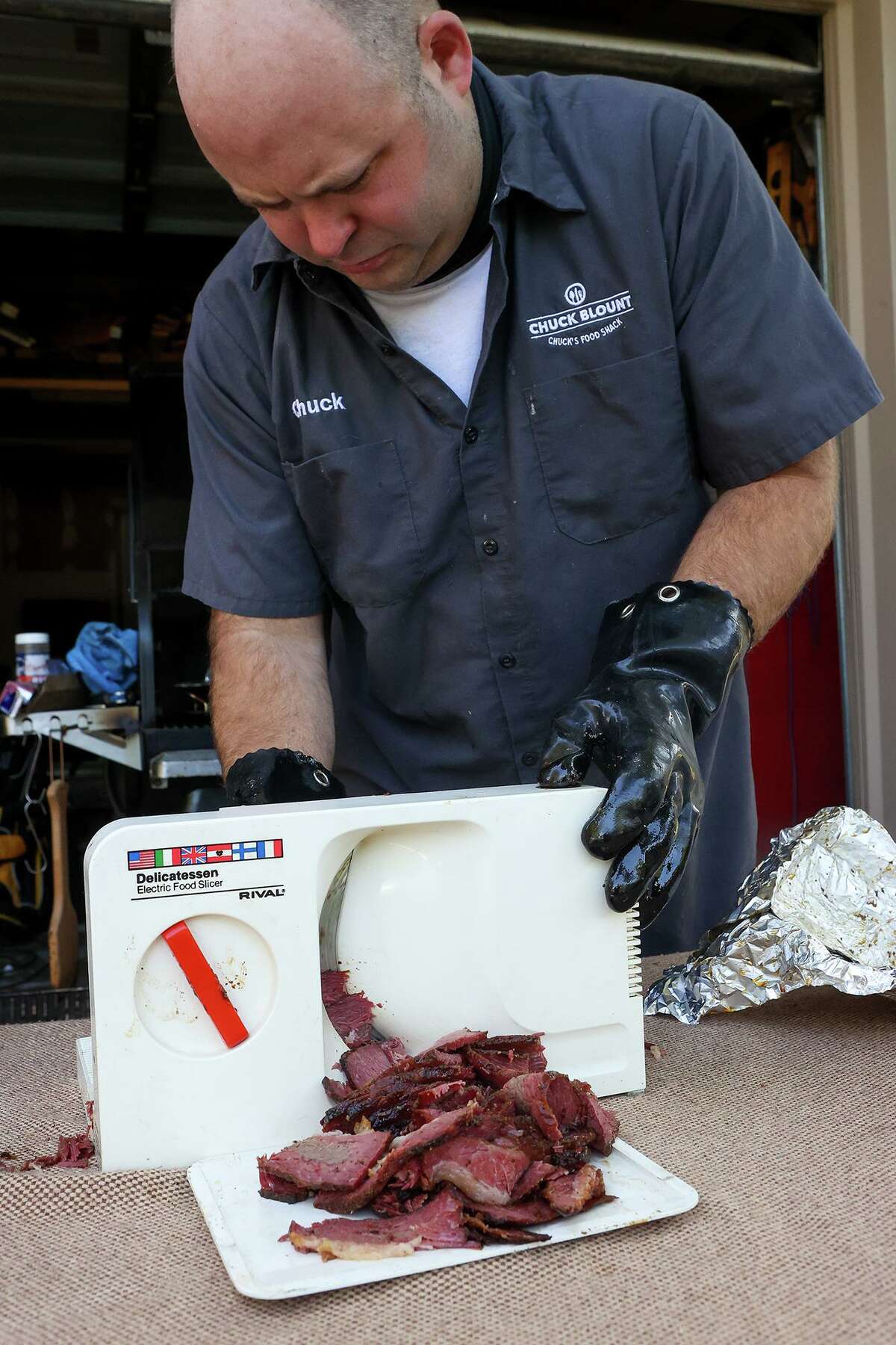 Chuck Blount slices pastrami into thin slices after it has gone through a lengthy brining process and nearly 10 hours of cooking.