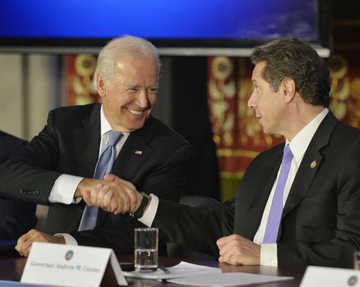 Vice President Joseph Biden, left, shakes hands with Governor Andrew Cuomo at the Capitol in 2014. If Biden wins the presidency, might he tap Cuomo for a role in his administration? (File photo)