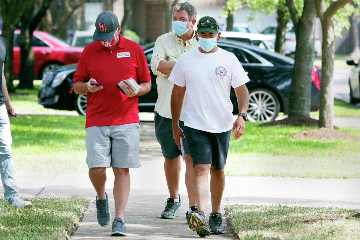From left, candidate Justin Ray, volunteer Chris Beavers and Orlando Sanchez, founder of Texas Latino Conservatives block-walk for Ray in a residential subdivision Saturday, Sep. 19, 2020 in Cypress, TX.