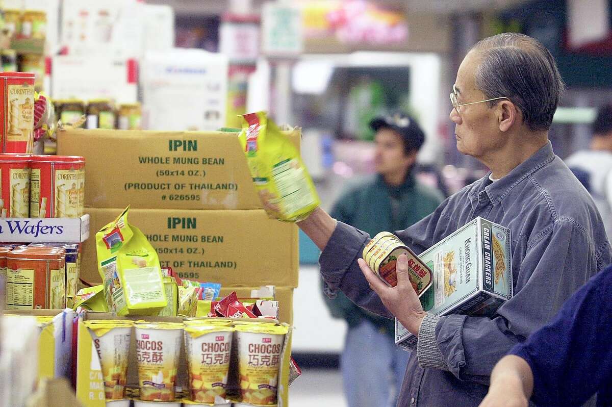 ETHNIC7B-C-15APR02-FD-PC A customer studied a product at 99 Ranch Market in Richmond. The grocery store chain is the largest Asian supermarket in the Bay Area. PAUL CHINN/S.F. CHRONICLE