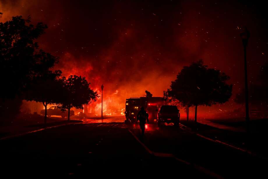 Firefighters intervene while a home bursts into flames from the Shady Fire as it approaches Santa Rosa, on Sept. 28, 2020. The wildfire quickly spread over the mountains and reached Santa Rosa where it has begun to affect homes. Photo: SAMUEL CORUM/AFP Via Getty Images