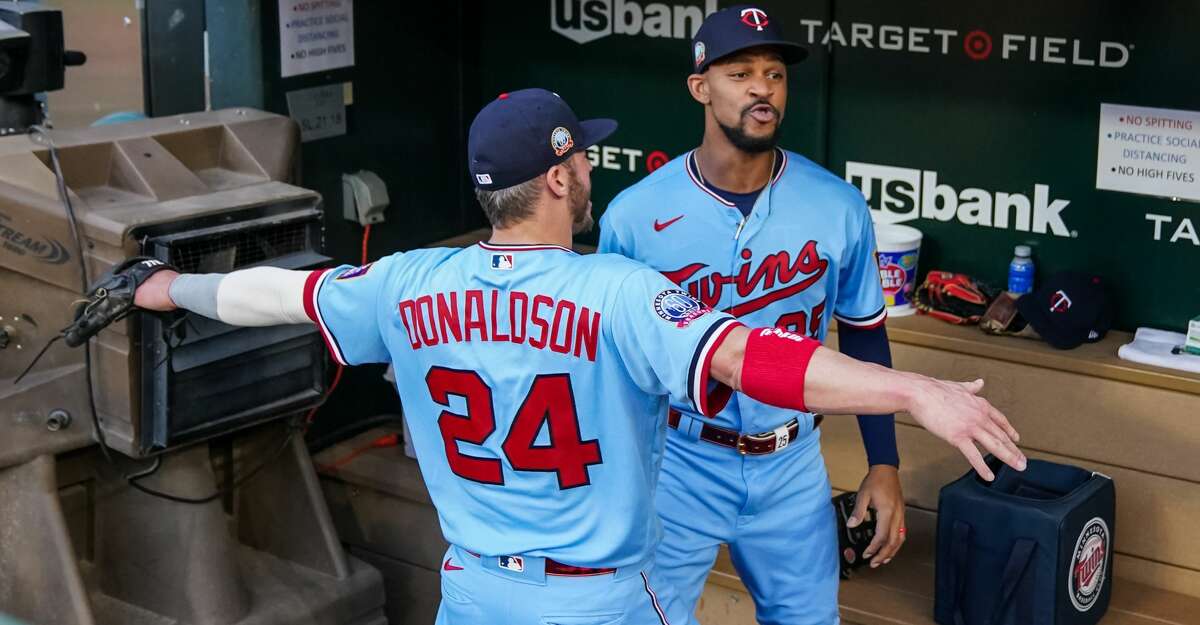 Byron Buxton #25 of the Minnesota Twins looks on with Josh Donaldson #24 against the Detroit Tigers on September 22, 2020 at Target Field in Minneapolis, Minnesota. (Photo by Brace Hemmelgarn/Minnesota Twins/Getty Images)