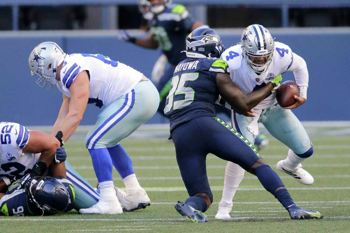 Dak Prescott faced steady pressure Sunday at Seattle as the Cowboys dealt with injuries along their offensive line.