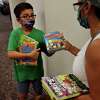 Dylan Rorick, 9, and his mom Glenda pick out books on the first day of reopening at the Trumbull Library in Trumbull, Conn. on Monday, September 28, 2020.