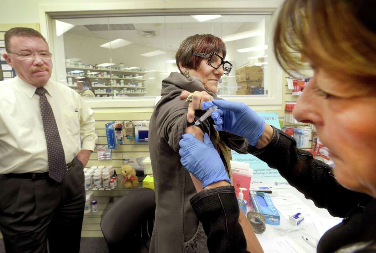 Rep. Rosa DeLauro gets a flu shot of the Flublock Influenza Vaccine from registered nurse Susan Manganello, of Protein Sciences, manufacturer of Flublok, as Richard Carbray, pharmacist and owner of Apex Pharmacy, left, watches at the Hamden drug store in 2015.