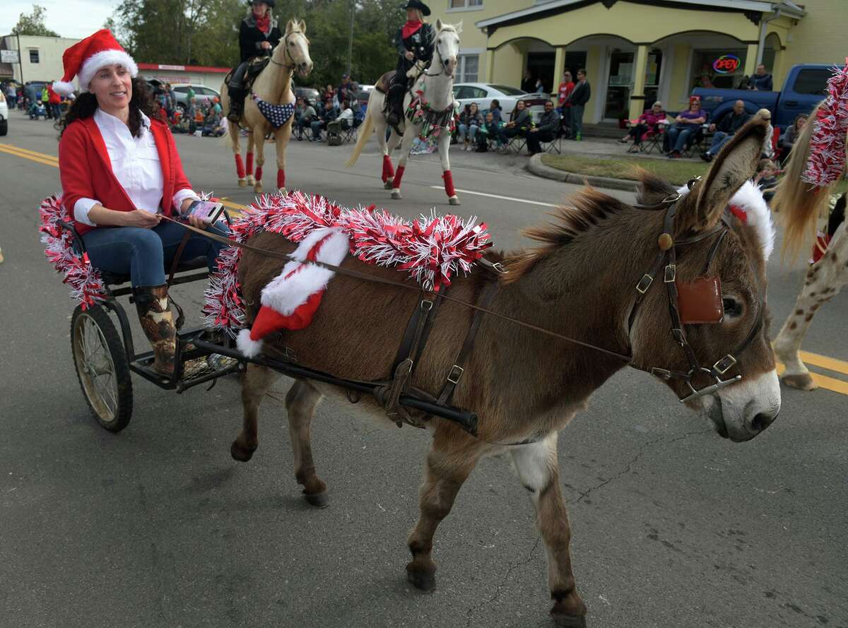 Julie Beth Yelin, of The Woodlands leads the "Eeyore Express" as part of the Auto Glass Installers of Tomball entry in the Tomball Christmas Parade on Main Street in downtown Tomball on Nov. 17, 2018.