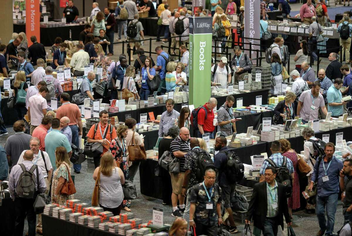 People look for books at tables set up by LifeWay Christian Resources, at the Birmingham-Jefferson Convention Complex, on the eve of the Southern Baptist Convention's annual meeting on Monday, June 10, 2019, in Birmingham, Ala.