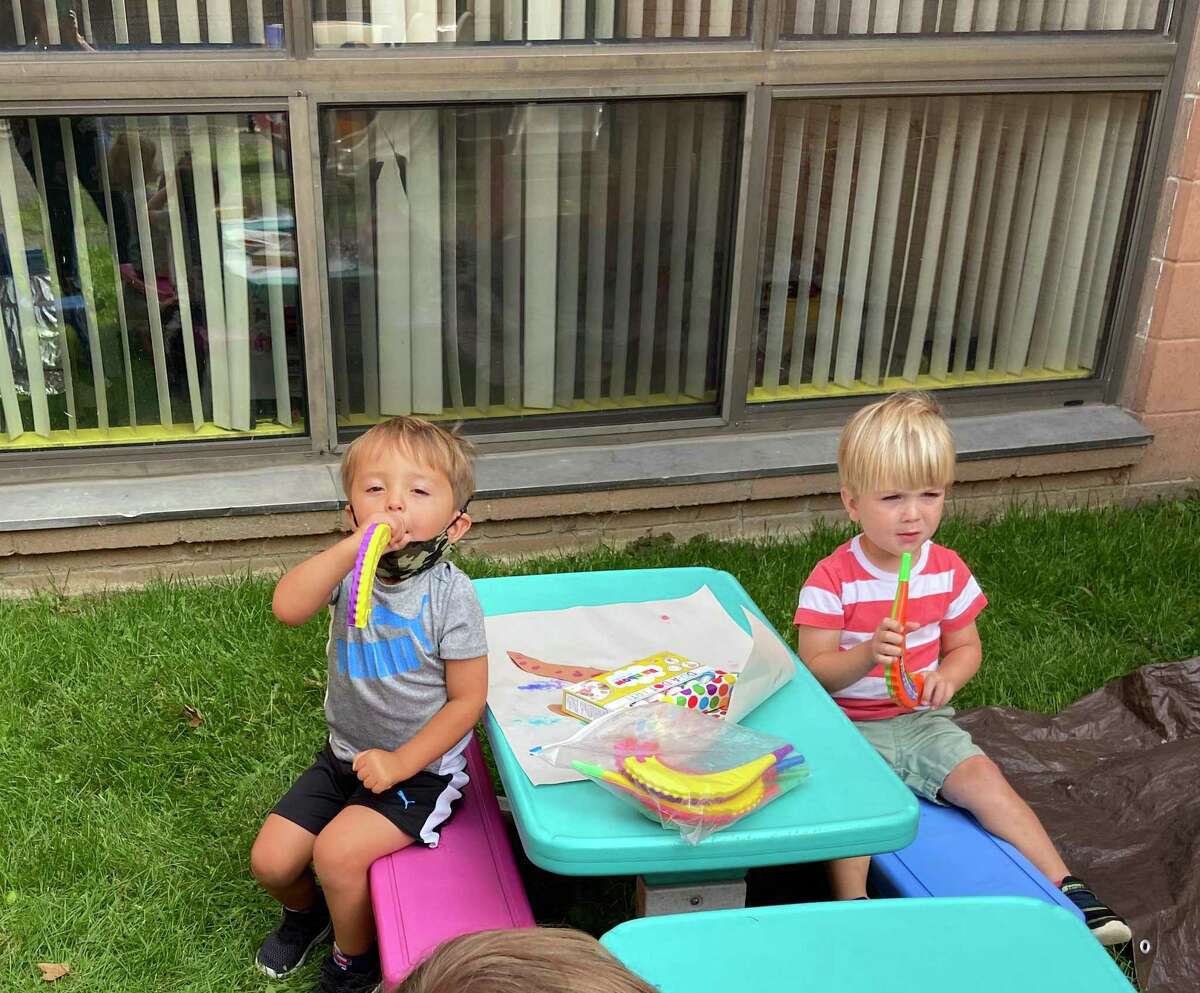 Children at B'nai Torah Nursery School blow shofars (pretend rams' horns) for Rosh Hashanah, the Jewish New Year, which began Friday, Sept. 18 at sundown. Apples and challah are dipped in honey for a sweet new year.