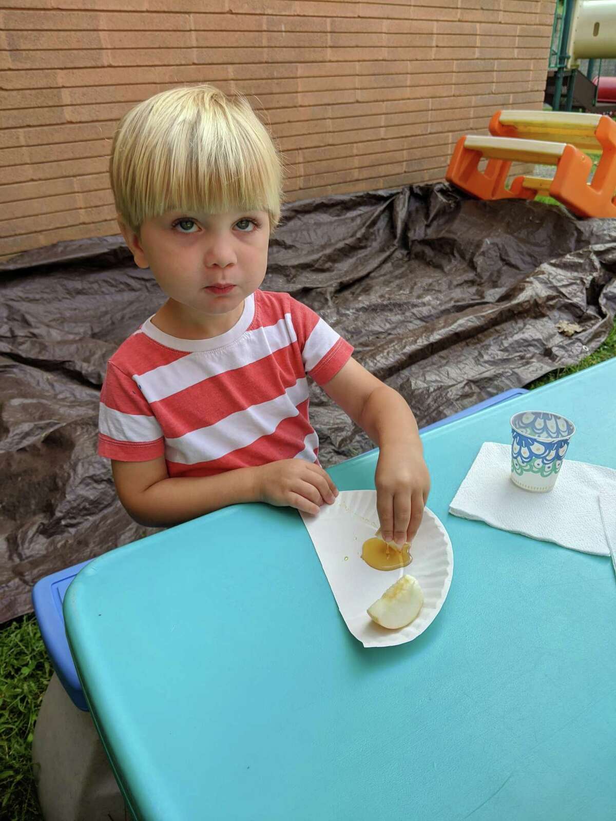 Children at B'nai Torah Nursery School blow shofars (pretend rams' horns) for Rosh Hashanah, the Jewish New Year, which began Friday, Sept. 18 at sundown. Apples and challah are dipped in honey for a sweet new year.