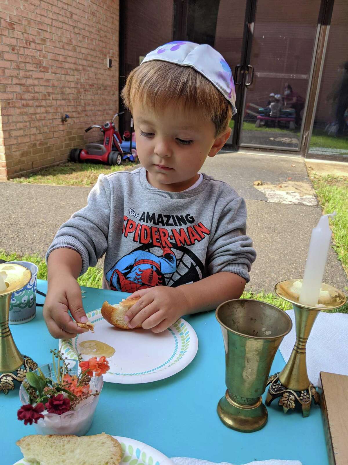 Children at B'nai Torah Nursery School blow shofars (pretend rams' horns) for Rosh Hashanah, the Jewish New Year, which began Friday, Sept. 18 at sundown. Apples and challah are dipped in honey for a sweet new year.