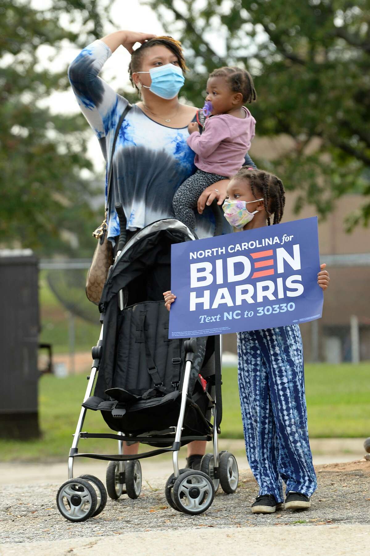 Supporters of Democratic vice presidential nominee Sen. Kamala Harris show their support Monday on the streets of Raleigh, N.C.