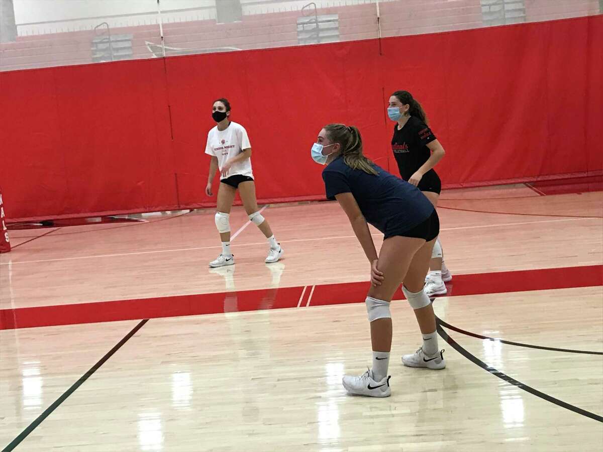 Chelsea Cleary, front, positions herself during the Greenwich High School girls volleyball team’s practice on Tuesday, Sept. 29, 2020, in Greenwich, Connecticut. Cleary is a senior captain of the Cardinals’ volleyball team.