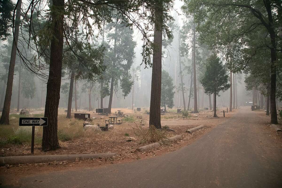 This photo provided by Chuck Bennett shows smoke from the Creek Fire filling the air at an empty campsite in Yosemite National Park on Thursday, Sept. 17, 2020. The National Park Service closed Yosemite National Park on Thursday for air quality concerns. (Chuck Bennett via AP)
