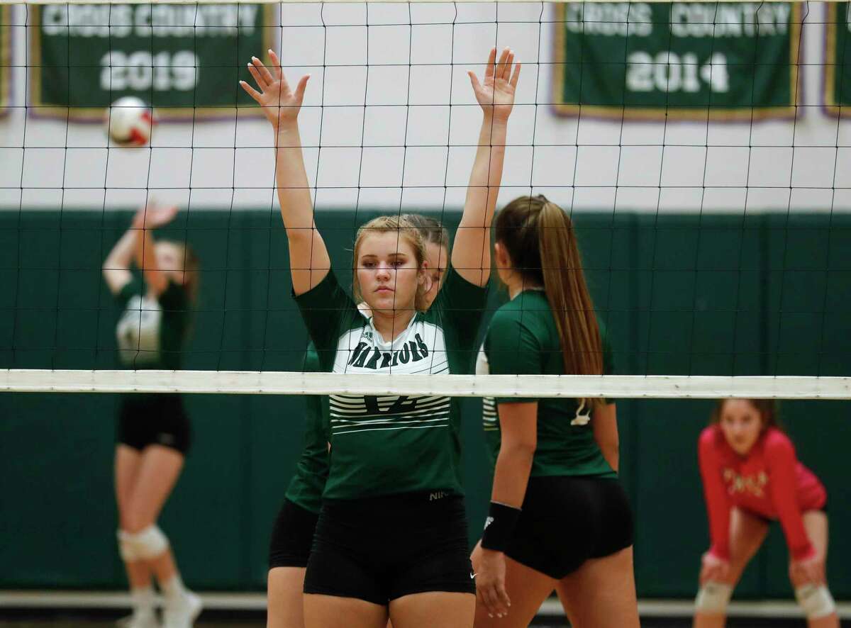 The Woodlands Christian Academy middle hitter Katie Tucker (12) awaits a serve during the second set of a TAPPS high school volleyball match at The Woodlands Christian Academy, Tuesday, Sept. 29, 2020, in The Woodlands.