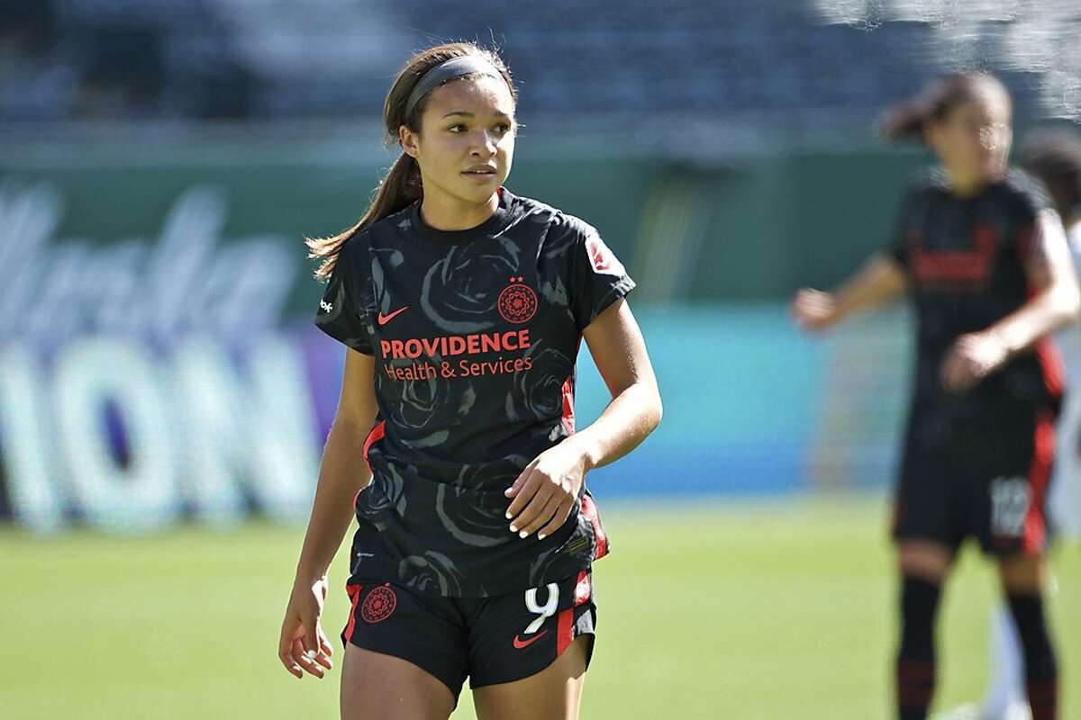 In this photo provided by the Portland Thorns, Portland Thorns' Sophia Smith looks on during an NWSL soccer match against Utah on Sunday, Sept. 20, 2020, in Portland, Ore. The No. 1 pick in the National Women's Soccer League draft and U.S. national team prospect, Smith comes from a family of basketball players — and it was just assumed she'd head in the same direction. Turned out Smith was right to choose soccer. It paved her way to Stanford, and now to a career in the NWSL. (Craig Mitchelldyer/Portland Thorns via AP)